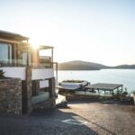 Sun Piercing of Brown Concrete House Near Sea